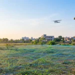 Surveyor checking AAI NOC requirement on a plot near an airport